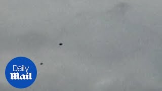 UFOs over England Five mysterious donutshaped objects filmed hovering in the sky [upl. by Etnad879]